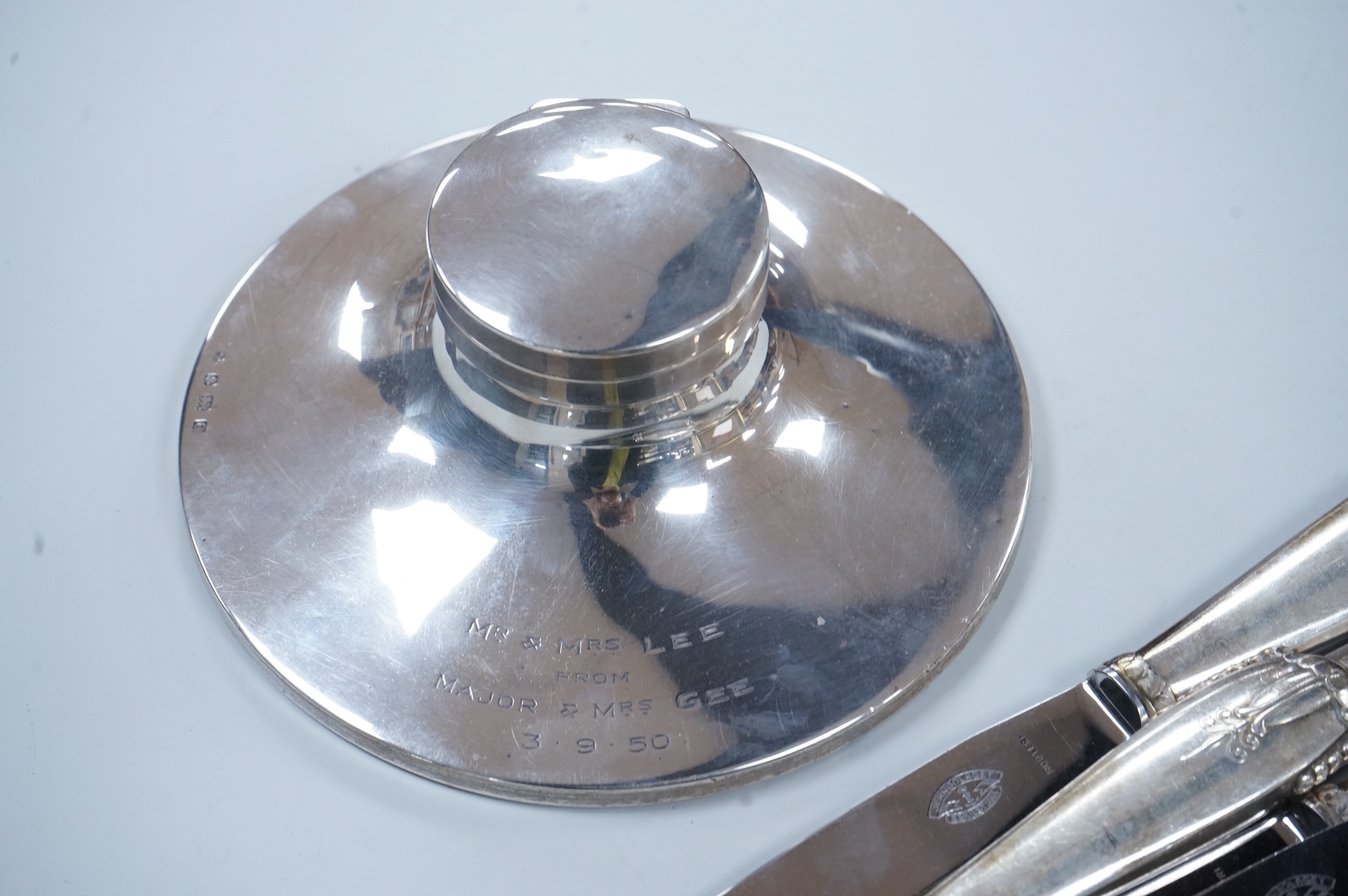 A George V loaded silver capstan-shaped inkwell, mm. W N Ltd, Birmingham 1931, 16.5cm diameter and twelve various Danish loaded silver handled knives with stainless steel blades
